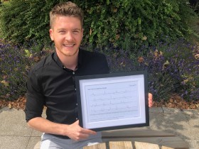 Picture of Matthew holding a certificate