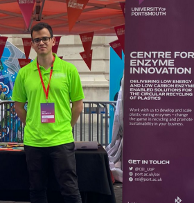 Konstantinos standing in front of an event stall
