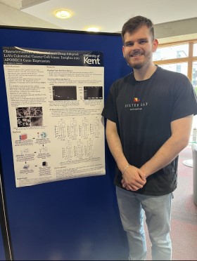 Mackenzie Stevens standing next to his project poster